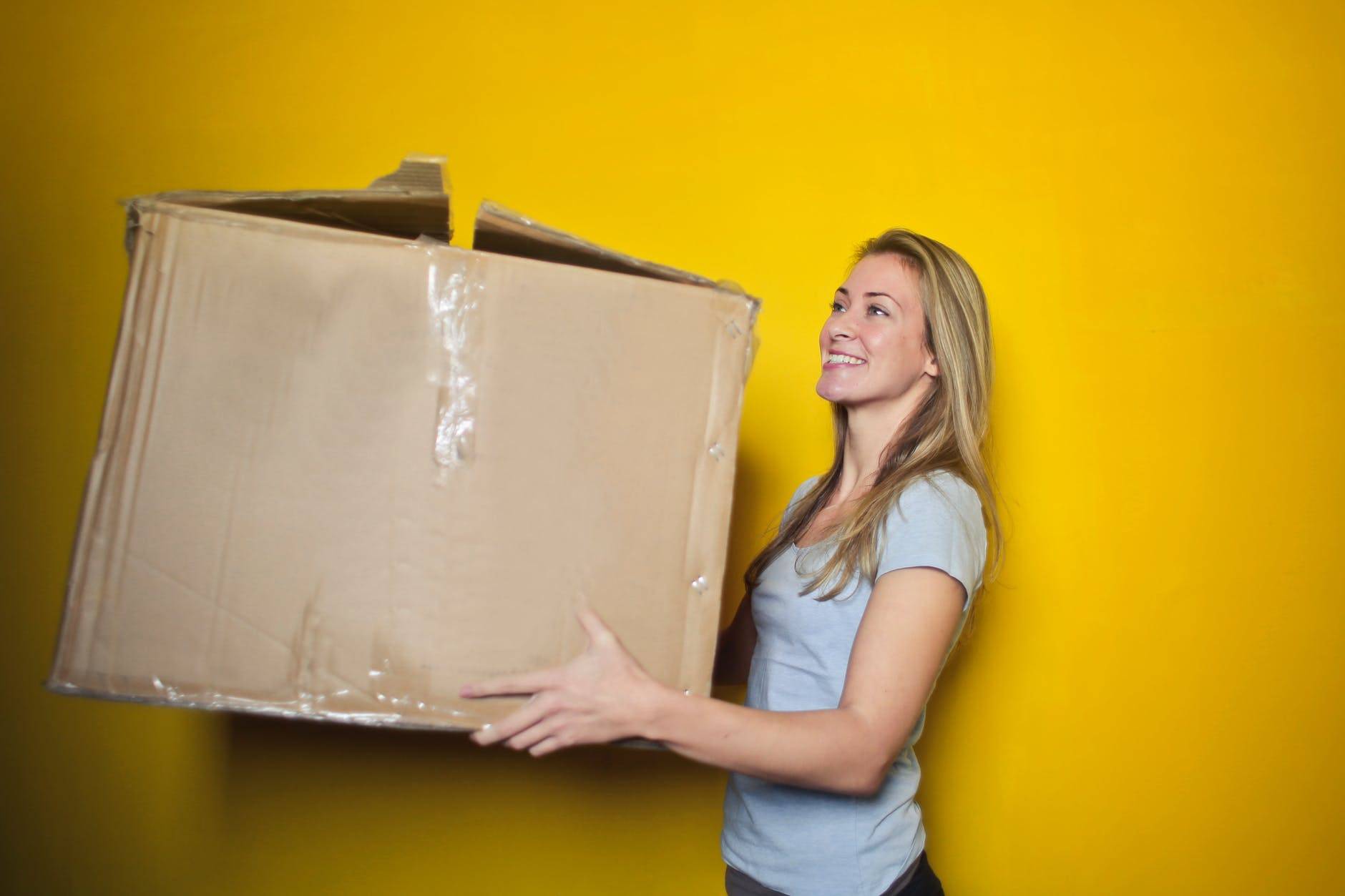 Woman with her online printing delivered package